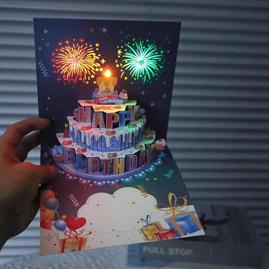 Tarjeta de cumpleaños con fuegos artificiales, tarta emergente y música